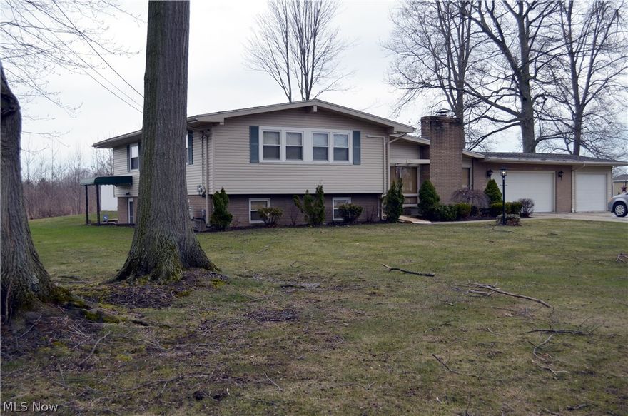 Lovely split level home with 4 bedrooms and a double lot with mature trees.  It is accented by the in ground pool surrounded by white fencing and concrete/composite decking.  The paved drive leads to a three car garage with plenty of storage.  Inside you will find solid oak cabinetry and newer appliances that stay.  On one side of the kitchen you have a family room with brick fireplace (gas or wood) and on the other side a dining room with glass sliders to the outside entertainment area.  A formal living room completes the main floor.  The second floor has 3 large bedrooms with a full bath across the hall.  The spacious master suite includes a full bath with double sinks, plenty of counter space, walk in shower and a walk in closet.  The family media room is on the lower level and includes a full wet bar.  Next is the recreation room perfect for work out equipment or pool table.  The large laundry room is also on the lower level and has washer/dryer and plenty of cabinetry for storage plus a covered walk out to the yard.  This is a home designed for a busy, active family.  It provides room to  live and play.  Picture yourself sitting by the pool this summer as you have your first cookout for friends and family.