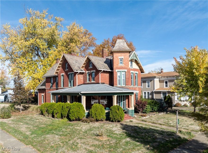 Stunning historical Heritage Home built for John Hostetler in 1885. Remodeled tastefully to preserve all the exquisite Victorian period design. This home has 5-6 bedrooms, 3 1/2 baths, a main floor and second floor laundry room, and is situated on a large 92x198 corner lot. There is a grand open spiral staircase in the main foyer and a separate back staircase. The first floor has 10-foot ceilings, 2 sets of folding double doors, working transoms, gorgeous built-in cabinetry, natural woodwork and hardwood floors. There are 2 master suites, one on the main floor and one on the second level, each with private baths with walk-in tile showers. The kitchen has granite countertops, a center island, and includes all the appliances. There is a formal living room and a separate family room on the main floor. The attic has also been finished for additional living space. Outside you can enjoy the private courtyard with a hot tub and a covered wrap around front porch. The outbuilding was the original wash house on the property. There are 3 decorative fireplaces, and a zoned heating system with 2 gas furnaces, and 2 central air units. There is also an outside well pump that is fed by a rainwater system. This property is currently being used as a profitable vacation rental property and can be purchased with all the furniture for an additional $15,000.