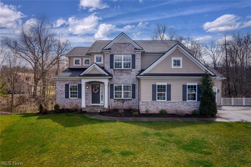 Nestled on a cul-de-sac enveloped by CVNP and perched atop a timbered ravine w a winding creek, it’s the beau ideal of peace, privacy and beauty. This north-facing 4 bed, 3.5 bath custom-built colonial boasts Petros quality construction and is outfitted for entertaining! Comfortably work from home in your private den. The spacious formal dining room accommodates more guests for hosting holidays. It is strategically located to obscure kitchen clutter, ensuring sophisticated dining. Triple windows in the great room welcome abundant light and backyard splendors, while the gas fireplace creates an inviting gathering space. Home cooks will appreciate the kitchen's walk-in pantry, underlit cabinets, granite countertops, a 5’ center island—befitting pastry and pasta-making—w pendant lights and breakfast bar, and a sink w wooded views making for scenic dishwashing. The dinette's nearly 7’ counter is ideal as a serving/coffee station. The large mud/laundry room is complete w a boot bench, folding counter, cabinets and built-in sink. Upstairs, your owner's suite is positioned amongst the lush backyard canopy for privacy and includes a linen closet; large WIC w attic access; and bathroom w dual sinks, walk-in shower, soaking tub, enclosed commode and windows for natural light. Also on 2nd floor is a large linen closet, a full bath w dual sinks, and 3 additional bedrooms–one has a bonus room! In the finished basement, full-sized windows maximize light and picturesque sights. The full bath and a bedroom w a closet make this level perfect for overnight guests (or 2nd den/craft room). Bask in the sun on your elevated south-facing deck, accessible from both the dinette and garage, to easily stow outdoor furniture and have friends join your BBQ. Your parklike backyard is a slice of paradise with a meandering creek, undulating landscape and mature trees bestowing verdant vistas, seclusion, soothing birdsongs and wildlife sightings. Walk to Hemlock Creek Trail (adjoins Towpath Trail)!