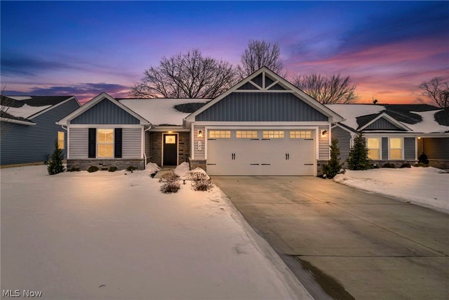 Welcome to 141 W Spring St in Elyria, located in the sought-after Ridge Water community. This fully upgraded ranch offers true one-floor living with thoughtful design and modern finishes throughout. Featuring 3 bedrooms and 2 full bathrooms, this home welcomes you with an open and airy floor plan filled with natural light. The kitchen is the heart of the home, complete with granite countertops, stainless steel appliances, a spacious center island, pantry storage, and stylish designer selections that elevate the space. The kitchen, dining, and living areas flow seamlessly together, creating the perfect layout for everyday living and entertaining.
The owner’s suite is a private retreat with a generous walk-in closet and a beautifully appointed en-suite bath featuring a double vanity and a Roman style walk in shower. Two additional bedrooms and a second full bath offer flexibility for guests, family, or a home office. Convenience continues with first-floor laundry and an attached two-car garage. Step outside to your stamped concrete patio, an ideal space to relax, host, or enjoy your morning coffee. With many upgrades above the base model, this home stands out. Enhancements include irrigation and sprinkler system, upgraded luxury flooring, custom lighting, stamped concrete patio, and elevated design finishes throughout. Enjoy low maintenance living with an HOA that covers lawn care, snow removal, and gutter cleaning, giving you more time to enjoy your home and less time on upkeep. Located near I-90, I-80, parks, shopping, and dining, this property offers the perfect blend of comfort, convenience, and style. Special financing available for qualified buyers. This home qualifies for a conventional loan with 0% down, NO PMI, and $3,000 toward closing costs. Schedule your private showing today!