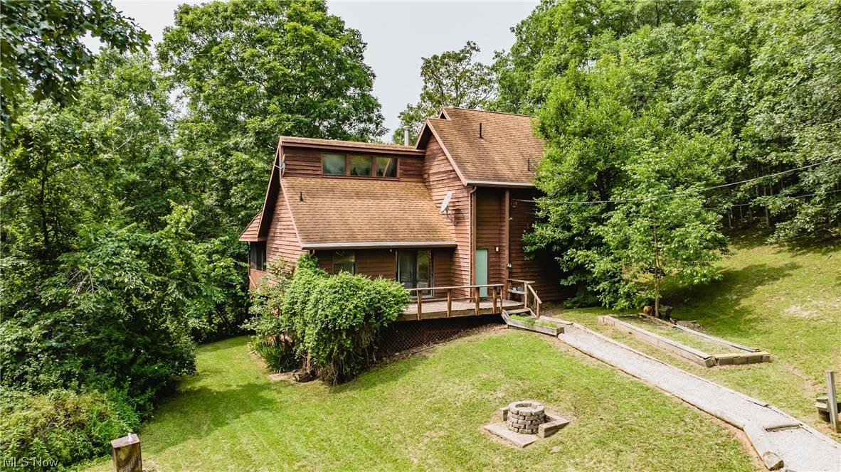 Your Country Getaway has now been found. This wooded piece of WV Heaven offers privacy, wildlife, and a quaint modified A-frame with 12 x 10 screened porch and generous decking. *Shown as a BR on the Blueprints, Owner used it as an Office, as there is a wall of windows. Hard roads have been freshly blacktopped and a good gravel driveway leads you to the generous 24' x 24' separate two car garage, with concrete floor. One door is 9' x 8' and the second is 8' x 7' plus man door. The former owner chose to continue using the well for his water source. There is a Clay Wood fire hydrant on the left side of entrance driveway entrance. A few adjacent neighbors have public water. Enjoy spectacular Fall and Winter views or watch "Spring come to Life!" But remember, "Summers are Cooler in the Country!" Immediate Occupancy available.
Important side notes: A new sump pump will be installed, discharging any water from the soon to be installed interior French Drain; presently, the electrica