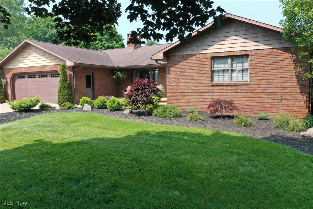 Welcome to this superb sprawling ranch. This one-owner brick beauty has been pampered like royalty. Nestled on 5 acres of Western Holmes County’s finest, a concrete driveway—leads you to this dreamy abode. Boasting 4 bedrooms, 3.5 bathrooms, and a grand total of 3,754 square feet (with 3,042 of those being prime living space), it’s your personal paradise. Sidewalk wines through the well-manicured gardens that lead you to your dream home. Inside, stunning hardwood floors sweep across an open concept living area, complete with a cozy family room, elegant dining space, and a chef’s delight of a kitchen. With oodles of cupboards and counter space, a butcher block island, and a coffee nook, this kitchen is a culinary playground. All kitchen appliances are staying for new owners. The first updated full bathroom features tile floors, a grand vanity, and cabinets galore. The owner’s retreat dazzles with dual closets, a linen closet, a spacious vanity, and a posh full bathroom with a walk-in tile shower that screams luxury. Two more bedrooms offer roomy closets. The living room, with its wood burner, has sliding patio doors that open to a private deck where sunshine and shade dance. Bonus: the hot tub stays, ready for post-unpacking relaxation! Full Basement that was just remolded (ALL of the floors are LVF). Rec room (pool table will stay), 2nd family room with Gas Erb Fireplace and New (only used twice) kitchenette with eye catching counter tops and brick wall that offers a little extra. Large 4th bedroom with huge walk-in closet. Updated half bath and large utility room (fridge will stay) completes the lower level. New water well installed Spring of 2025 along with new water system. Charming bridge offers easy access to the remainder of the property. Welcome Home!