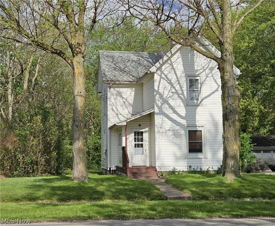 Attention handy buyers and investors - don't miss your opportunity, because it won't last long! Bring your creativity and unlock the potential to make this 3-4 bedroom, 1.5 bath colonial within walking distance to historic downtown Wadsworth your own! The first floor, accented by high ceilings, features a kitchen with ample storage, large open-concept dining room/living room area, half bath, mud room with built-in storage, plus a bonus room that could be used as additional gathering space, office, or a possible fourth bedroom. The second floor features three bedrooms and a full bath. Additional amenities include a full basement, 2-car detached garage, and enclosed front entrance. Needs work, but many major components are done: roof replaced approximately 2019, furnace and HWT replaced 2021, vinyl siding (date unknown), most windows are vinyl replacement (date unknown). Sold as-is, buyer is responsible for their own due diligence. Schedule your private showing today!