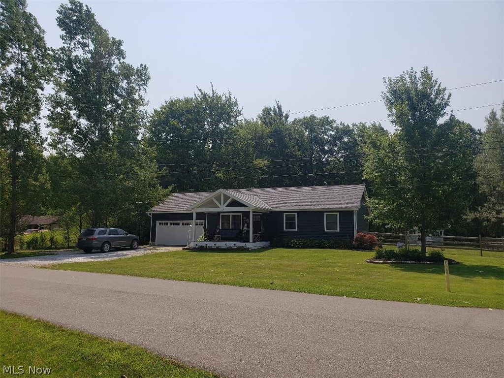 Straight out of Homes and Gardens Magazine. This house does not disappoint. This house sits on a large double corner lot with over a half acre of land. The newly fenced in yard has plenty of grass area and minimal upkeep. The house is across the street from the lake with a gorgeous view. Beautiful front porch for lake views and morning coffee was added in 2020. Walk in to the open living room/kitchen /dining area with all new walls, floors, island and exquisite design. The kitchen was completely updated with new cupboards in 2018, new granite counter tops and sit down granite island. Three bedrooms upstairs and bath with attached laundry. The bathroom was completely updated in 2020 with state of the art fixtures and breathtaking tile work. Walk down stairs to the Family room/bonus room/bedroom with full bathroom. Walk out to the back on the newly added deck for relaxing or family cookouts. The exterior was completely redone in in 2020 with new siding, windows and garage door with keypa