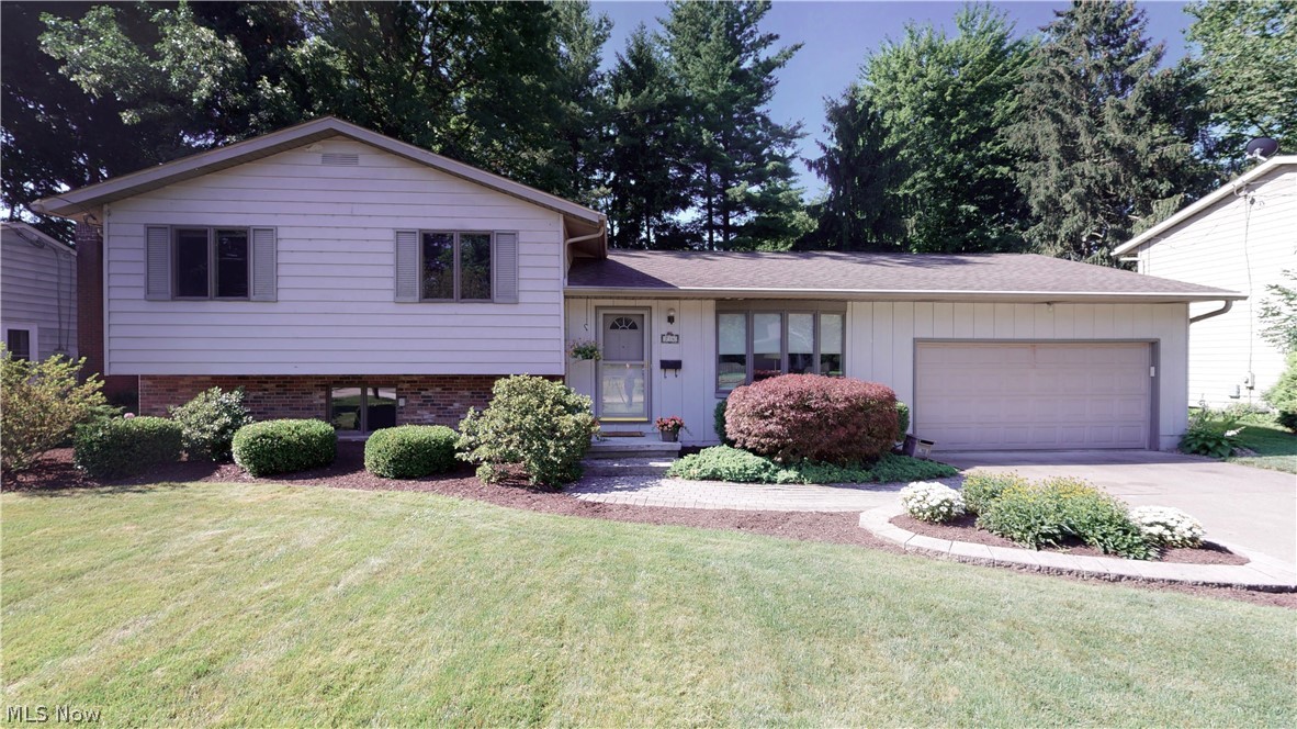 MUCH to love in this Kent, Ohio split! It starts with Curb Appeal and Setting... on the edge of Kent's Highland Park which becomes an extension of your yard without the maintenance! WOW... only a few homes in Kent can offer you that! Location demands your attention--walking distance to Kent State University, accessible to south-side shopping, restaurants, close to Routes 261,43 & 76! This turn-key property offers large shaded deck, doggie door into outside fenced area w/ dog house, original restored hardwood in living room & wide entry hall (as well as hardwood under all bed carpets if one is interested in exposing). The built-ins, closets, and overall storage--incredible! Enjoy the open concept granite kitchen with nicely-kept cabinets into great room w/ gas fireplace and vaulted ceiling and--the most incredible part--amazing windows to the back yard~! Newer paint throughout, new on-trend carpeting in all bedrooms. Above-grade lower level family room w/ new laminate flooring/paint of
