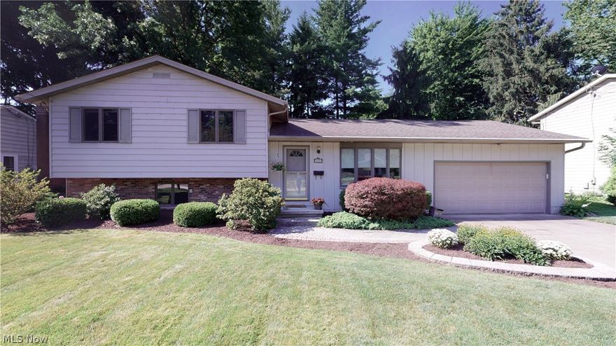 MUCH to love in this Kent, Ohio split! It starts with Curb Appeal and Setting... on the edge of Kent's Highland Park which becomes an extension of your yard without the maintenance! WOW... only a few homes in Kent can offer you that! Location demands your attention--walking distance to Kent State University, accessible to south-side shopping, restaurants, close to Routes 261,43 & 76!  This turn-key property offers large shaded deck, doggie door into outside fenced area w/ dog house, original restored hardwood in living room & wide entry hall (as well as hardwood under all bed carpets if one is interested in exposing). The built-ins, closets, and overall storage--incredible! Enjoy the open concept granite kitchen with nicely-kept cabinets into great room w/ gas fireplace and vaulted ceiling and--the most incredible part--amazing windows to the back yard~! Newer paint throughout, new on-trend carpeting in all bedrooms. Above-grade lower level family room w/ new laminate flooring/paint of