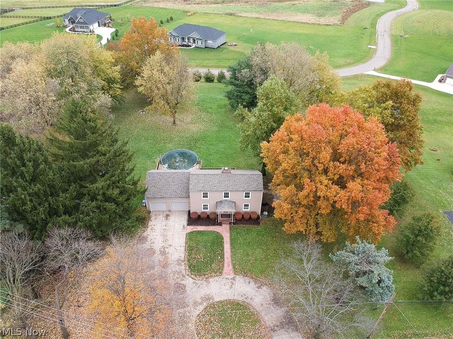 Rustic saltbox on 1.7 acres at 13658 Market Ave N. in Hartville, Ohio, with immediate possession. Two story foyer entry. Cozy great room offers a wood burning fireplace and access to the deck and back yard. Fully applianced kitchen, and separate dining room. First floor master has its own access to the deck , and a full bathroom across the hallway. The second floor has a loft area, overlooking the foyer,  three additional bedrooms, and a full bathroom. The lower level is finished with a spacious recreation room and a half bath. There is an above ground pool with decking , and wonderful open back yard! This home has great potential, but could use a little TLC!