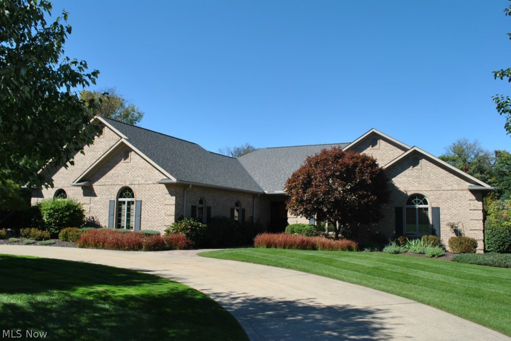 Spectacular,1-of-a-kind,custom blt full brick ranch w/6+ car garage.Custom Andersen windows & 6 paneled wood doors.Shows like a model w/an open flr plan & neutral decor throughout.Foyer/custom front door,newer tile flr.Stunnng kitch/custom cabints,newer granite counters & backsplash,plus tile flr.Spacious family rm w/cathedral ceilng,custm FPlc,newer carpetng.Beautiful formal dining rm/custom wood flr.Office/Den w/custom wood panelng on 1st flr,also Master BR, bth, walk-in closet & door to custom deck.There's a total of 3 BR's & 2 1/2 bths plus a laundry rm on the 1st flr.Lge loft area.State-of-the-art remodeled walk-out lower level w/Great rm,rec/play rm,20x19' workout room,custom wet bar/2nd kitch area w/newer flr & cabinets,could be an extra suite if needed.Newer hot tub/sun rm off walk-out lower level w/custom ceiling & paved flr.2 staircases to heated 6+car garage w/workshop w/built-in cabinets,stove,refrig.This garage is perfect for a car buff.Lge private cul-de-sac lot,professio
