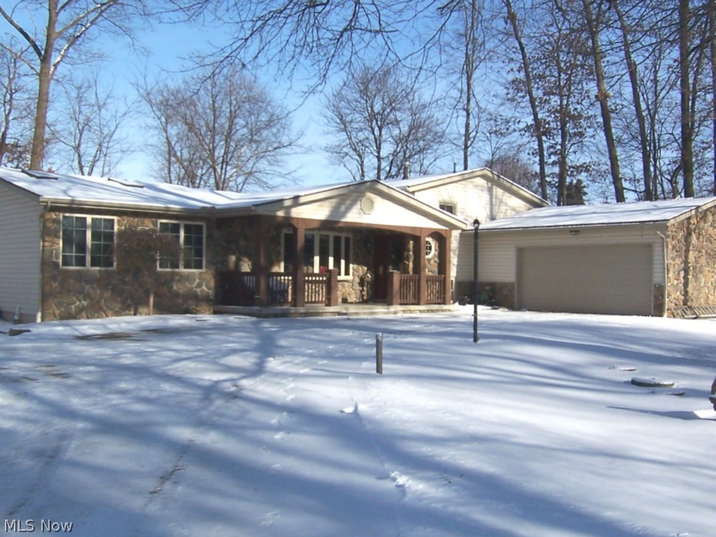 You will fall in love with this rustic split level home nestled on just over an acre of beautiful, partially wooded land in Hartville! This home boasts a log cabin themed family room with wood beamed walls and ceiling, and a stone wood-burning fireplace. There is an abundance of living & storage space in this 2200+ sq ft home. This lovely home features 4 bedrooms, 2 1/2 baths, a 1st floor laundry w/storage cabinets (exit door replaced-2013), & a mud room off garage. The fully appl oak kitchen has a newer window and lots of cabinets. The half bath on lower level was updated in 2013. The Master Suite is on the first floor, and the master bath includes a Jacuzzi tub & step-in shower. (The Master Bedroom Suite would make a perfect in-law suite). The oversized 2 car garage w/workbench has a newer steel entry door & service door, as well as garage door opener (2010). The large deck, accessed from the sliders in the dining room (replaced in 2013), is perfect for entertaining or enjoying a mor