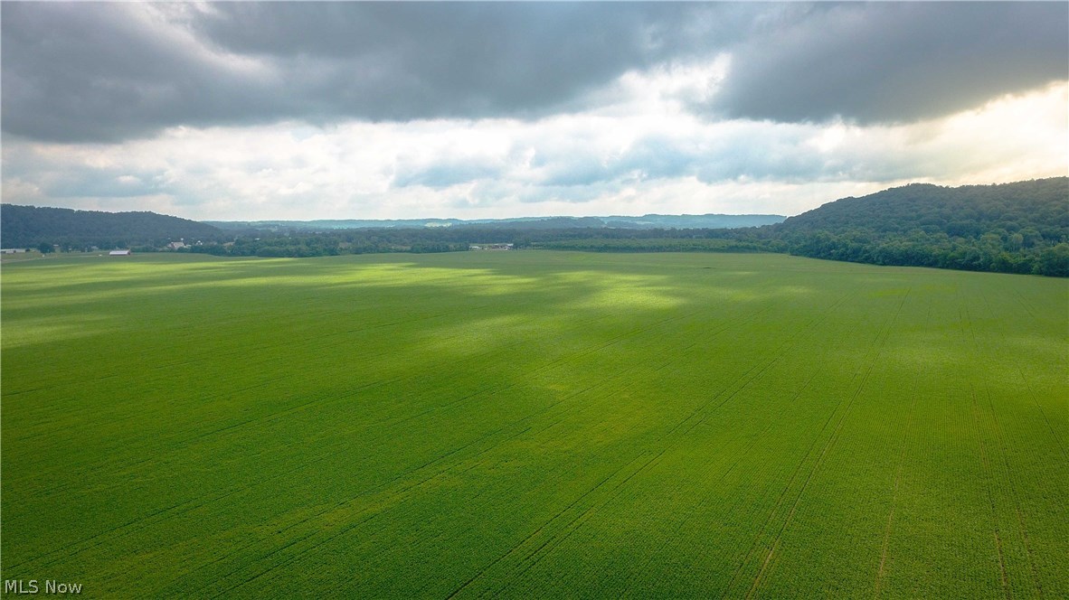 Over 3000’ frontage of prime tillable acreage nestled up against the Tuscarawas river. The land speaks for itself, do a drive by and admire the large amounts of contiguous flatland and over 240 acres of rich soils. Also, an excellent opportunity for future commercial growth with prime lots ranging anywhere from 14 acres to 109 acres. HBP gas/oil rights will transfer with the property. Majority of the property sits in the 100-year flood zone, maps available for flood zones, soil maps and soil capability maps are available online, via our online interactive mapping software. Tenant farmer has right to harvest this seasons crops.