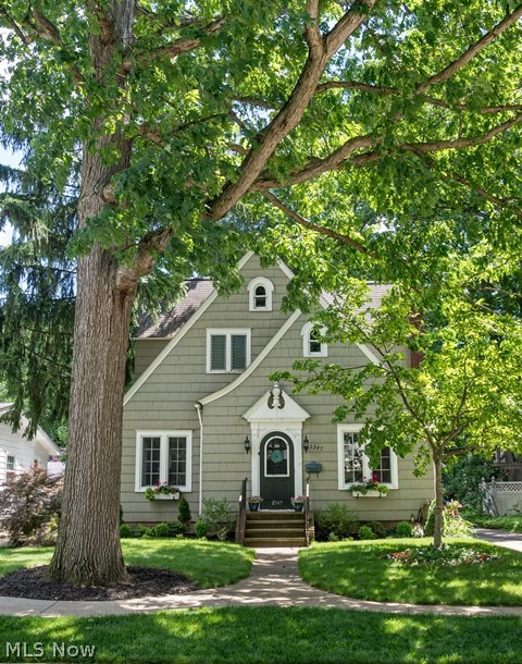 A real beauty. This charming chalet colonial is a must see. The seller has lovingly done extensive work with all hardwood floors, freshly painted, new windows in most of the house including storm/screen combos for living room, dining room and office. There are new ceiling fans and light fixtures. There is crown molding in the living room and dining room that adds character. All appliances stay. In the master bedroom there is a large wood paneled walk-in closet updated with bead board interior walls and wired lighting. In the second bedroom there is also a walk in closet. The decorative trim around fireplace has a hidden cord.
The basement is divided into several rooms and has been waterproofed with a transferrable life time warranty. There is laminate flooring and baseboards in most of the basement. There is a craft room, a photography studio, work room and storage. Must see to appreciate. The flagstone patio was reinstalled and expanded, along with a brick walkway to the