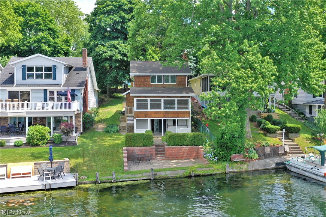 Welcome to this lake home that sits on the West Reservoir of Portage Lakes! This home boasts stunning views of the lake throughout and is a short boat ride away from the restaurants on the lake! A living room with a beautiful fireplace that opens to a stunning three season room. This three season room is the perfect spot to sit on these long summer days and watch the boats go by. Two nicely side bedrooms and one that includes an ensuite. A walk out basement that leads to steps down to a patio. This patio will be your entertaining spot all summer long! Â With some TLC this house will become your perfect home, for lake life living!