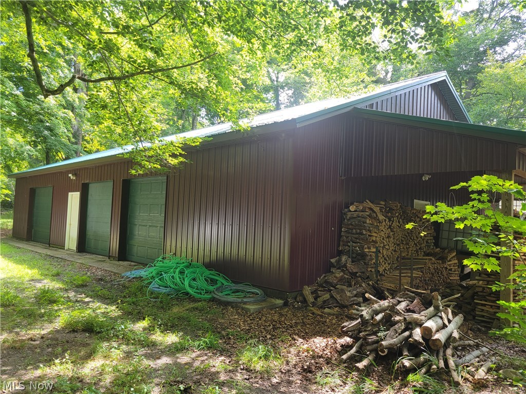 Nice rural location for your 3 bays of storage and heated and cooled workshop. No customer based businesses due to residential zoning. Must see driveway to determine if any vehicles could navigate the curved gravel drive and woods .
The garage has three 18'9" deep bays with 8' high doors (2 are 8W and 1 is 10'W). This part of the garage has additional storage nooks and workbenches for use and cold water to a washtub. The 19'6" x 39'6" workshop has heated flooring and an ac unit and 10' ceilings.
There is a 10x30 lean to on one side. The owner just reserves a 230sqft room for their person items.