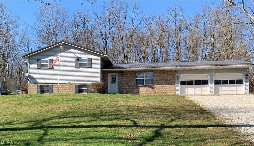 Situated on three private acres you will find this spacious five bedroom,  two bathroom home . Offering an open concept and many updates including updated bathrooms, finished hardwood flooring, newer carpeting along with a new metal roof and new gutters ! Attached is a two car garage and outside you will find your very own inground pool that is fenced in great for entertainment on those hot summer days . Home is located in Warren Local Schools. The house is here the land is here make your home here ! Motivated Sellers !