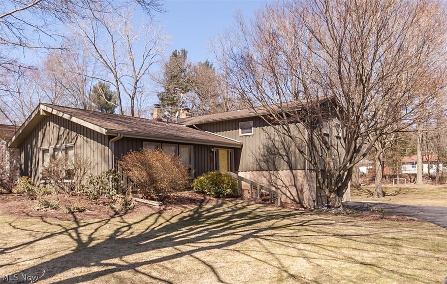Welcome Home... You're going to love 521 Beryl Drive in Kent, Ohio! This unique open-floor 4-Bed, 2.5-Bath Contemporary is situated on a wonderful wooded large city lot. Your "first look" will include a stunning vaulted Living Room that boasts large windows -- a beautiful & cheerful living space! Built originally by an architectural engineer, the property has been lovingly cared for the last few years by the 2nd family to ever own it & they have turned it upside down! Every bath has been touched, every inch of wall painted, new stainless appliances installed in kitchen and the good bones massaged. Zoned steam heat is comfortable, affordable and boiler serviced annually with a clean bill of health. In winter months, enjoy the gas fireplace in lower family room. All 4 bedrooms with original hardwood!! New electric panel & roof shingles were completed around 2013. (A complete list of recent improvements is posted on the MLS Supplements.) Great outbuilding (with kids' clubhouse in upper le