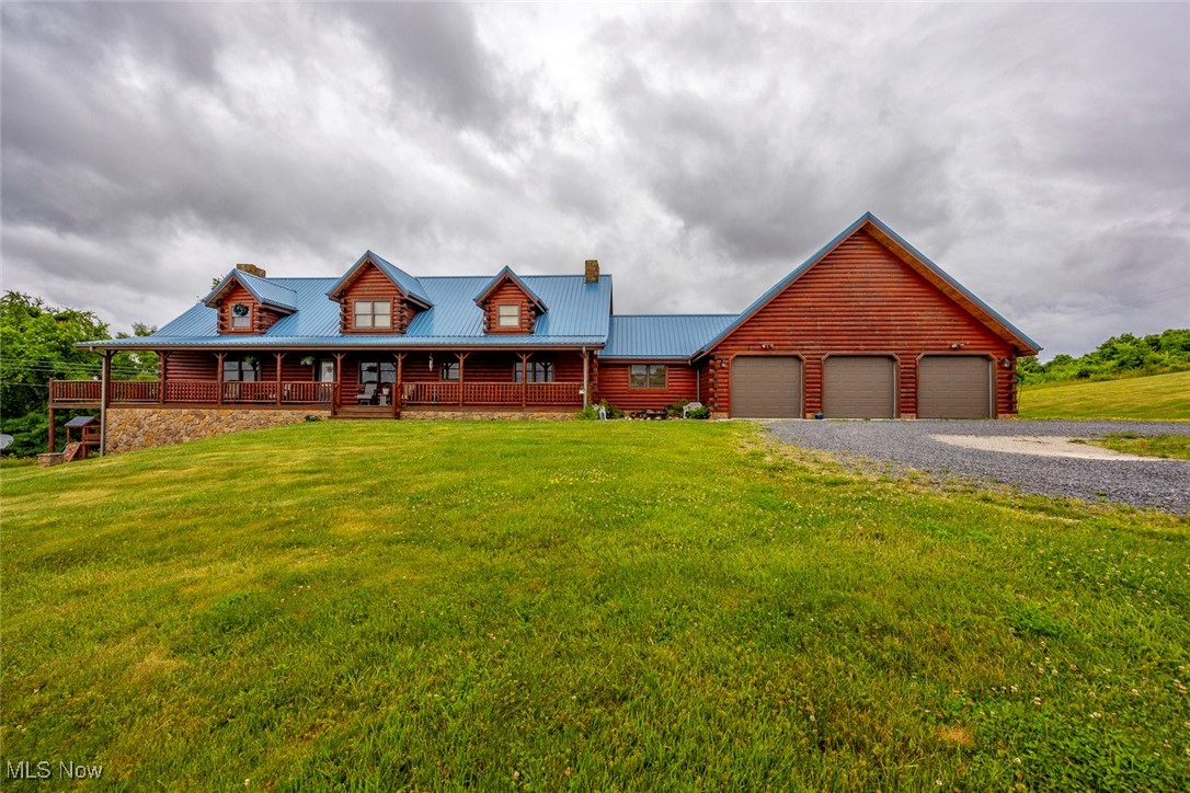 Come and see the Cadillac of log homes in a private country setting yet close to all the amenities for you to enjoy. This home has a 3 car attached garage along with a metal roof. The serene woods can be viewed from the very large wrap-around porch with a sun porch on one side. Walk into the rustic multi-grained hardwood floors with amazing large beams adorning the Cathedral ceiling throughout. The enormous eyebrow windows on each side of the gas-log fireplace offers a gorgeous view of the sky during winter months as you can cozy up by the fireplace and watch the snow fall. There are many kitchen cabinets alongside Corian style countertops. This story and a half home has 3 bedrooms on the first floor, 2 full baths, and laundry room. It has an amazingly large loft area with over 1000 sq. ft. with half bath (add shower to make a full bath). Loft can be made into bedrooms, family room, and/or office space. The view from the loft is stunning which includes the eyebrow windows, fireplace, huge living & dining room area. Full basement has 2 electric furnaces and electric water tank. Basement has a high ceiling that facilitates finishing it into family room, exercise room, office, or bedrooms, etc. Whatever your imagination can envision. A concrete patio is under the side porch. This home comes with approx. 4.41 acres to be surveyed off. Seller will consider selling more acreage.