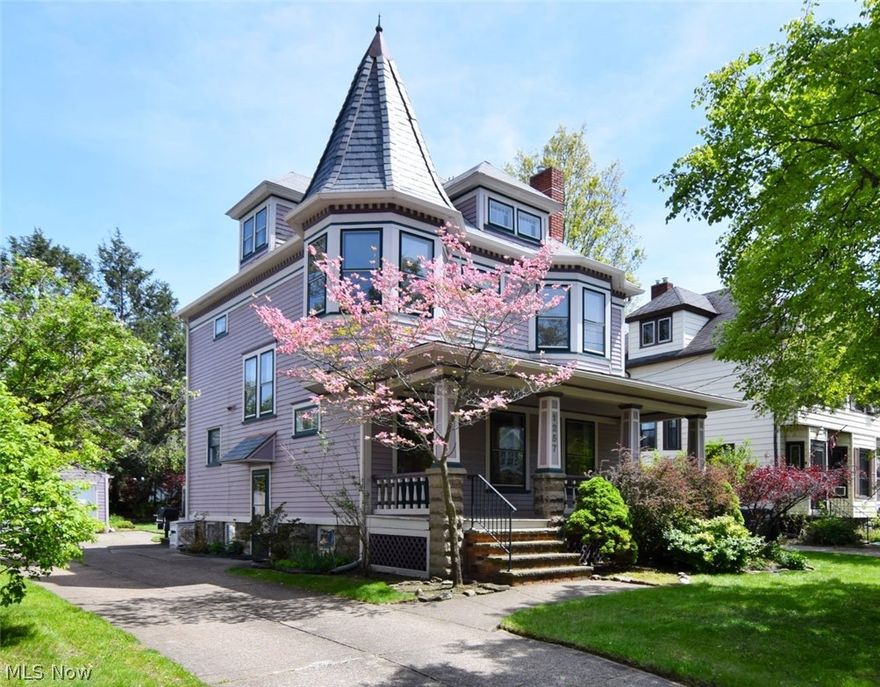 Welcome to this charming 4-bedroom front porch Colonial in the heart of Lakewood. This home masterfully preserves historic craftsmanship while offering modern updates including the kitchen, bath, roof, gutters & downspouts, back porch and some electrical. Designed for a vibrant, walkable lifestyle, it perfectly balances classic character with contemporary comfort.  Entry foyer features exquisite quarter-sawn oak doors, banisters, and matching floorboards. Spacious living room is highlighted by leaded glass windows and a woodburning fireplace with a marble surround. Living room and dining room has beautiful maple floors with cherry accents and original natural woodwork. Kitchen is a cook's delight with butcher block countertops, stainless steel appliances, glass display cabinets and a butler's pantry with lighted display & under cabinet lighting. 2nd staircase off kitchen leads you to 
4 bedrooms (one of the bedrooms has a newer back porch) and a newer updated bath with granite counter and tub/shower with ceramic tile surround & floor. Convenient Attic access from the hallway is ideal for storage or additional living space with the potential to finish the area. Full basement with laundry area & sink and newer toilet and sink with concrete shower base setup.
Deck & patio with gas grill overlook a park-like yard with mature trees and private fence. Sought after area of Lakewood within walking distance to parks, schools, shopping & restaurants. Home warranty provided!