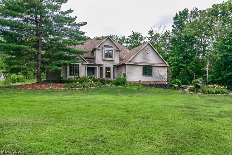 Welcome to a vacation you get to call HOME!  This beautiful 4 bedroom, 2.5 bath colonial is located on nearly 1.75 wooded acres in Chesterland! This home features over 2800 sq. ft. of living space including a FIRST FLOOR Owner's Suite w/ on-suite bath w/ jetted tub and stand-up shower. The eat-in kitchen offers granite countertops, center island, breakfast bar, and plenty of cabinet/counter space. The 2-story great room boasts a floor-to-ceiling stone fireplace, skylights, formal dining room w/ tray ceiling, 1st floor office, spacious 1st floor laundry room, 2-story foyer, full basement, an enclosed newly screened in porch with a double French door entryway. Enjoy the 2-car attached garage w/ plenty of room for storage and a sizable storage shed for all of your seasonal pool equipment. The newest makeover to this property includes the installation of a 30X14 INGROUND 5 ft deep POOL (2019). Complete with a desirable salt water filtered pool system & a substantial concrete patio which is completely enclosed with luxury vinyl fencing. Since moving in, the owner has added a reverse osmosis water system, installed a new furnace and a/c, freshly painted throughout and carpeted the great room. This home also includes shelving in the basement, gutter helmet, granite countertops in kitchen and 2 full baths, and a fully remodeled main floor 1/2 bath, updated light fixtures, and a newly installed dishwasher. The owner is including all kitchen appliances. This home is truly a must see!