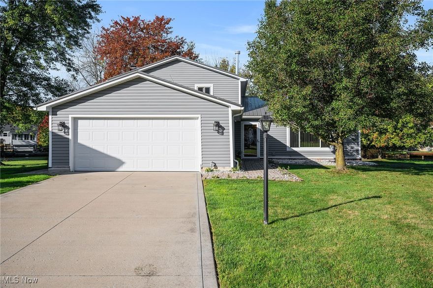 THIS could be THE PLACE!  THIS HOME IS A MUST SEE... 4 bed, 2 full bath home is situated in the much desired location of Aurora Shores, with a private dock and water access to Aurora Lake! Every inch of this home has been updated, and it just waits for you to move in! As you pull up to the home note the new driveway, front walk, vinyl siding and metal roof!! No overgrown landscaping here! All of that has been removed to provide you with a blank canvas!  As you enter this immaculately kept home notice the gleaming hardwood floors that run through the dining and living rooms. And it doesn't end there!  The completely updated kitchen has premiere stainless appliances including a 5 burner cooktop,  wall oven and microwave, high end dishwasher, French door refrigerator, as well as quartz counters, solid wood, 42" custom cabinetry, tiled backsplash, pantry and more!! As you head to the lower level, you will find a beautifully tiled  family room with fireplace, a bedroom, full bath and laundry area! Enjoy the view of this amazing property with the lower level walkout, glass enclosed patio, and an outdoor paver patio area! Enjoy every bit of your canal water view, amazing yard, and personal boat dock. The upper level does not disappoint either! With hardwood floors, large closets, master bedroom, 2 additional, nice sized bedrooms, and a fully remodeled bath. Additionally, there is a tankless water heater, newer windows, newer doors, newer garage door and an updated electrical panel. The only thing missing is you! The HOA includes 2 pools, Community Center, marina, tennis courts, playground, and volleyball courts!