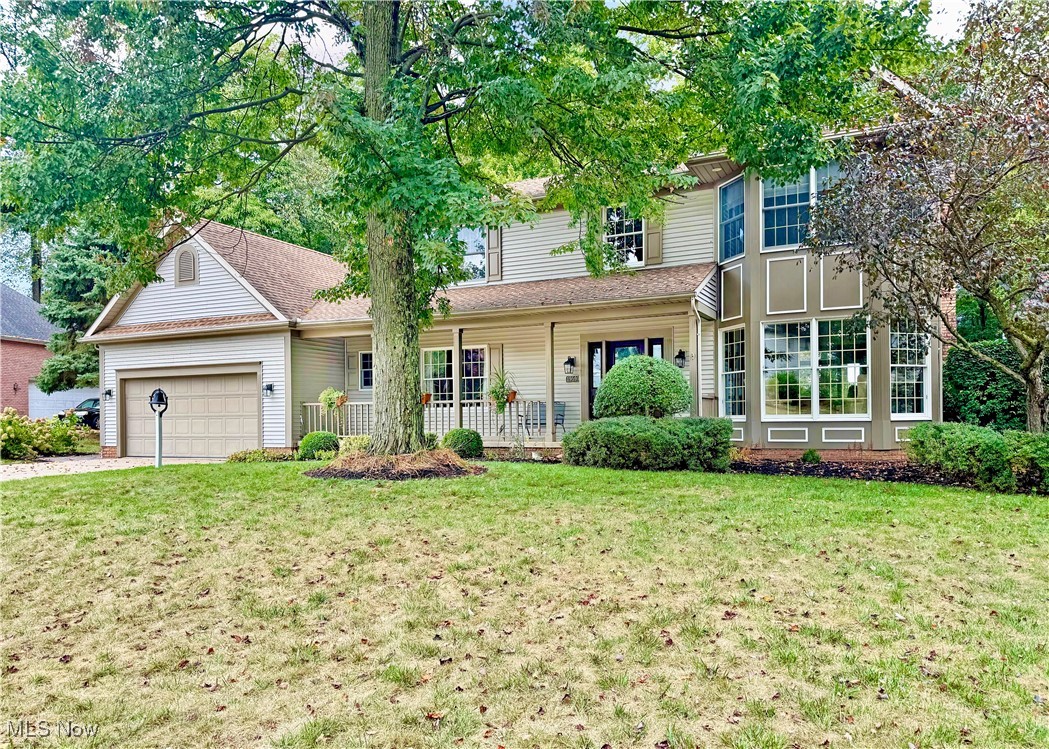 Welcome to this stunning 4-bed, 3-bath colonial nestled in the highly desirable Mayfair Lakes development, located within the Green Local School District. You’ll be charmed by the home’s timeless curb appeal, complete with a welcoming front porch accented by flower boxes and meticulous landscaping. Step into the two-story foyer, where an elegant chandelier and staircase set the tone for the home’s classic yet modern feel. To one side, the beautifully finished dining room flows into the updated kitchen (2018), featuring quartz countertops, trendy subway tile backsplash, stainless steel appliances, and ample storage. The thoughtful layout continues with multiple living spaces, including a formal living room, a cozy family room with built-in bookcases and gas fireplace, and a cheerful sunroom. A first-floor laundry and half bath add convenience to daily living. Upstairs, the expansive master suite is a private retreat with vaulted ceiling, walk-in closet, and updated ensuite bath. Three additional well-sized bedrooms and another full bath provide plenty of room for family or guests. The lower level offers incredible potential. The dry basement is already equipped with a supplemental gas heater and provides abundant storage. Finish this level to your liking and add up to 1,000 square feet of living space to this already spacious home. The backyard is a true highlight, offering a private, park-like oasis. Enjoy outdoor entertaining on the new (2021) paver patio with stone walls, or relax on the low-maintenance composite deck overlooking the lovely yard. A thoughtfully designed dry river bed not only handles seasonal water flow but also creates a beautiful, eye-catching creek feature at the back of the property. Additional updates include HVAC system, stove, roof, and whole house generator. With its combination of modern updates, abundant living space, and a stunning outdoor setting, this home is truly move-in ready and offers everything today’s buyers are looking for.