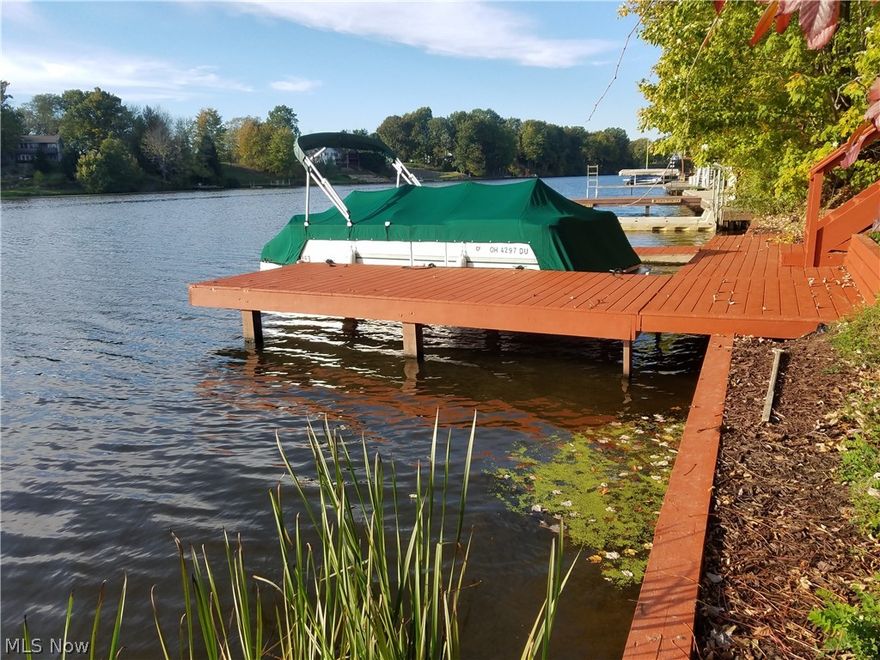 LAKEFRONT!!! This vacant, cleared, buildable, waterfront property is in the "No-Wake" zone but only about 2 football fields south of the main lakes ski zone.  Being in a No-Wake Zone it is quieter and can be so much easier on docking or boarding your boat and using the dock area for fishing.  With the Lot already cleared, you can begin enjoying it now and/or you have reduced expenses going forward to build.  Even the survey pins are found.  If your dream is to build your own vacation or retirement retreat, this is on the East side of the lake, so western facing for those fabulous Sunsets.  Great dock, Seawall and Steps are installed and have been well maintained.  The property has a stone drive and available city water, sewer, and available natural gas service.  Enjoy the boating and swimming right from your own dock on this 5-mile long lake of 550 acres. RomeRock Association offers two Heated pools, Beaches and a Clubhouse, pavilions, Tennis courts and more.  Just 60 minutes from Clev