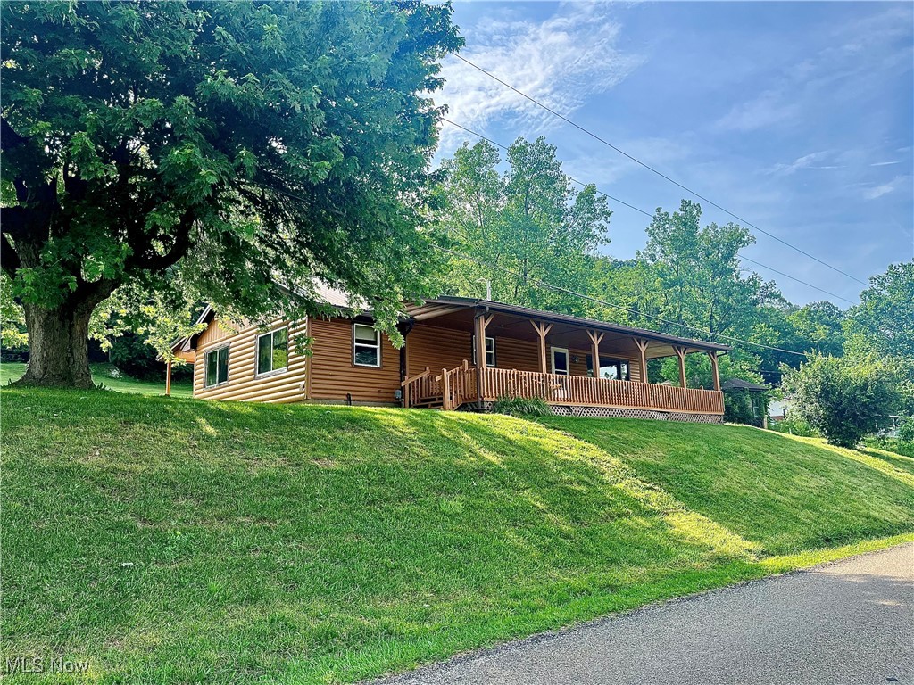 Enjoy scenic river views and peaceful surroundings with this charming 2-bedroom, 1-bath home situated on 7.01 partially wooded acres. The home offers potential for a third bedroom with a simple conversion, making it an excellent option for growing families or those needing extra space. Step onto the large covered front porch and take in the serene views of the river—perfect for relaxing mornings or quiet evenings. The home features attractive log siding and a durable metal roof for rustic charm and long-term peace of mind. A spacious 24x48 ft detached garage provides ample room for vehicles, tools, or hobby space. Recent updates include a new water pump installed in 2025. Whether you're looking for a weekend getaway or a permanent residence, this property offers a unique combination of comfort, acreage, and natural beauty. Listing agent is related to the seller.