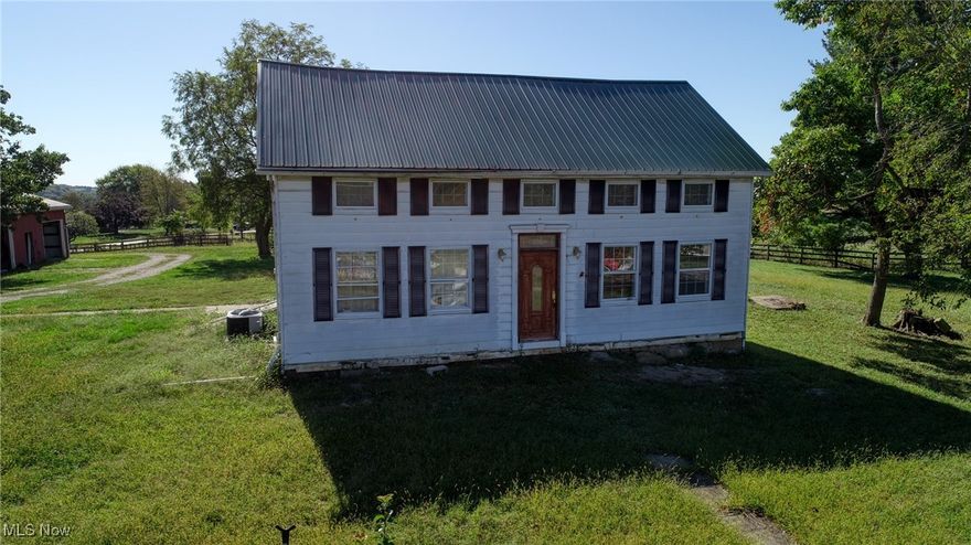 Discover the potential in this 1870 farmhouse set on 5+ acres in the East Muskingum School District. Offering 1,738 sqft with 4 bedrooms and 2 bathrooms, this property blends historic character with room for improvement—perfect for buyers ready to invest some work and vision into making it their own. Inside, you’ll find an eat-in kitchen, formal dining room, living room, and a main-floor bedroom with full bath. Upstairs offers three more bedrooms and a second full bathroom. While the home needs repairs and updates throughout, some key improvements include a new metal roof (2023), new furnace (2022), and professionally leveled and stabilized floors (2017). Equestrian and hobby farm enthusiasts will appreciate the 30x35 stable with five stalls, tack room, hay loft, and water supply. The 2½-car garage, fenced areas, and pasture fields add even more value for livestock or horses. This is a short sale and will be sold as-is. With vision and effort, this property could become the country retreat, mini farm, or homestead you’ve been dreaming of.