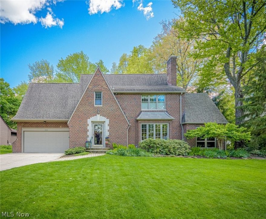 This Silver Lake Estates Brick Tudor is situated on a 1/2 acre private lot and it includes Silver Lake privileges! Filled with charm and character throughout and maintained with excellence. Entering through the  foyer you'll find gorgeous hardwood floors in almost every room, all have been refinished.  There's a formal living room  and formal dining room  featuring a wood burning fireplace, crown molding and the original oversized picture window brightening the front room with natural light. Adjacent to the living room is a cozy screen porch/sunroom with natural stone floor. The beautifully updated  kitchen has cherry cabinets, a cooks island,breakfast bar, granite counters & stainless appliances.This area is an  open concept floor plan encompassing the kitchen/family room/ breakfast room addition that includes a  fireplace with gas starter, two walls of windows showcasing  the lush park-like backyard plus two sets of french doors leading out to three stone patios. The breakfast room h