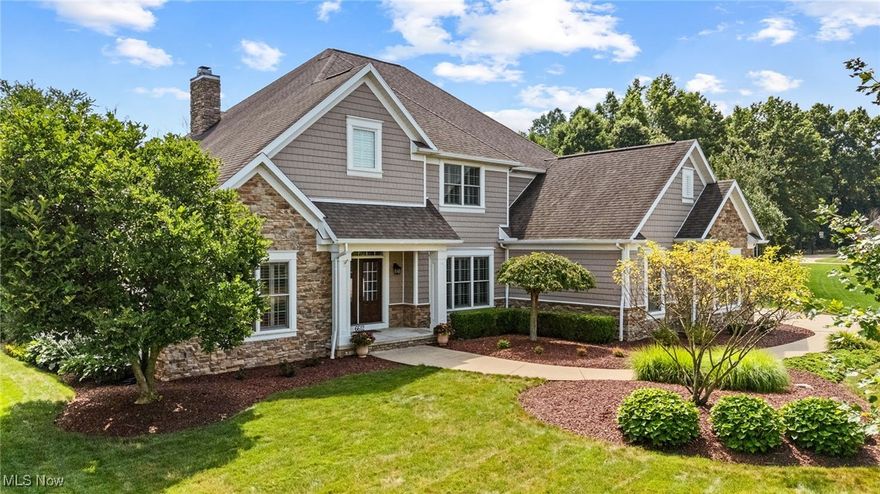 This custom Memmer home in Mudbrook Village offers 5000 sq ft of living space, designed with family living and entertaining in mind, including an 1800 sq ft lower level! Tucked on a quiet cul de sac and built with incredible quality throughout, it offers plenty of room for everyone to spread out, come together, and feel right at home. A vaulted, beamed foyer sets the tone and leads into the great room, where a soaring ceiling, wall of windows, and fireplace make it a natural gathering space. The open kitchen is just steps away, featuring granite countertops, a tiled backsplash, stainless steel appliances, a walk in pantry, breakfast bar, and casual dining area, perfect for busy mornings or everyday meals. Hardwood floors continue into the formal dining room with classic wainscoting and plantation shutters. With the master suite tucked away on the main level, it’s easy to enjoy a quiet space of your own, complete with a walk in closet and spa-like bath with a jetted soaking tub, double vanity, and glass enclosed tile shower. Upstairs, a cozy loft makes a great reading nook along with three more bedrooms and two full baths, including a junior suite with its own private bathroom. The finished lower level adds even more flexibility with a spacious family room featuring a coffered ceiling, a wet bar, craft or studio space, and a fifth bedroom with access to a modern full bath, ideal for guests, older kids, or multi-generational living. Outside, the backyard feels like your own private sanctuary. The screened porch offers a quiet place to unwind, while the expansive paver patio is made for entertaining with a built in grill, firepit, and plenty of space to gather. Thoughtful landscaping surrounds the yard, and a fenced area gives pets a safe place to roam all tucked into a peaceful setting that feels worlds away, yet close to everything. A 3 car side load garage and a prime location near Jackson schools, shopping and dining round out the full package. Don't miss this!