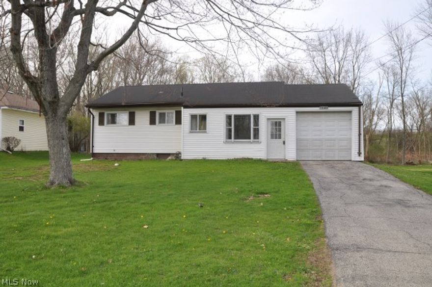 Perfect starter or retirement home w/large family room addition that leads to a handicap accessible deck w/wooded view. Eat-in kitchen w/range & refrigerator, large living room, 3 bedrooms, hardwood floors throughout, an attached single car garage & enclosed front entry. This home also has ne windows, vinyl siding & an added 12" of insulation in the attic. Shingles are provided for new roof installation, although the roof is currently leak/problem free at this time.