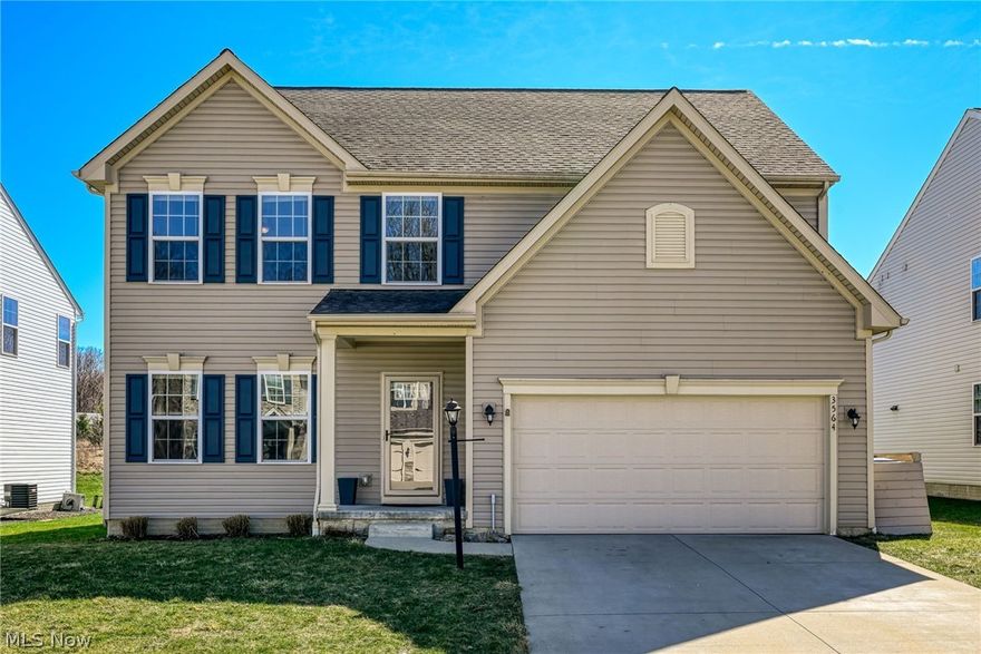 Welcome to this bright and cheerful Colonial located in the highly sought-after Liberty Ledges community of Twinsburg. Built in 2018, this move-in-ready home offers the convenience of first-floor living with plenty of room to grow. The kitchen is both stylish and functional, featuring abundant cabinetry, a center island with breakfast bar, a large pantry, and included appliances. The kitchen opens seamlessly to the Great room, creating the perfect layout for everyday living and entertaining. A sliding door off the eating area leads to the deck and backyard, where a private path provides direct access to the scenic trails and natural beauty of Liberty Park. The first-floor owner’s suite serves as a private retreat with a tray ceiling, an en-suite bath with double sinks, an oversized shower, and a generous walk-in closet. Finishing off the first floor are a laundry room, a half-bath, and an office or formal living room. Upstairs, you’ll find three additional bedrooms, a full bath, and a versatile loft space, ideal for a second office, playroom, or relaxation area. The unfinished basement offers excellent potential for additional living space and already includes plumbing for a future bathroom. Located in the Twinsburg City School District with convenient access to highways, this home perfectly combines comfort, style, and an incredible connection to nature. Schedule your showing today and make this home your own!