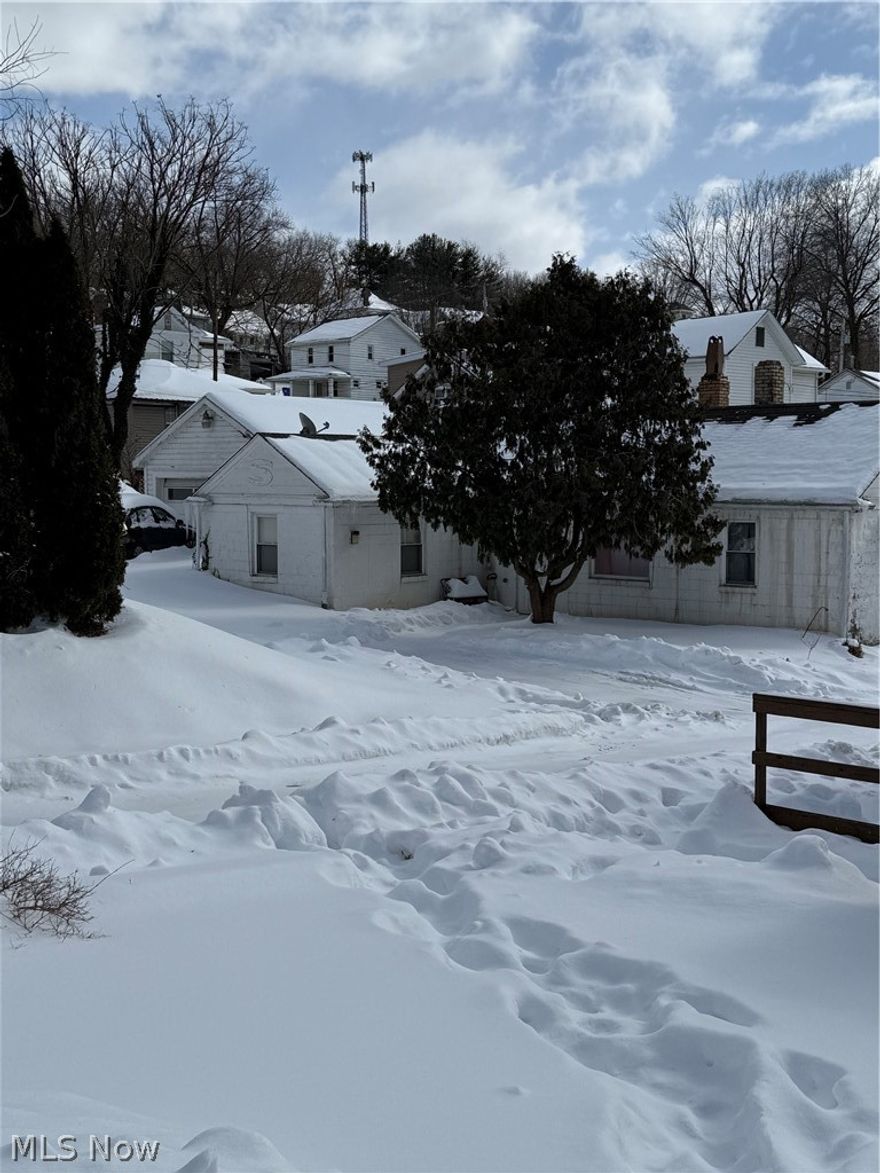 Perfect little home for single with child or elderly person. Would make good investment property as well, low maintenance. House is on a slab, no steps to get up or down . Plenty of storage in 2 car garage. Sits back off quiet alley with own driveway. There is a small yard that actually sits up on Riverview street, house sits down in alley.