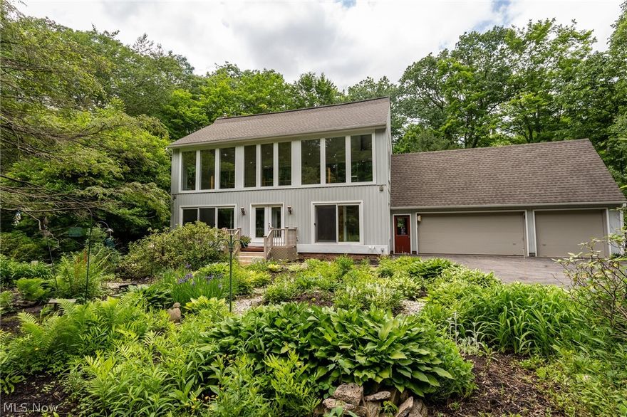 Happy home in search of new owners!! Amazing opportunity to own this modern contemporary home nestled away on the wooded Twin Mills Lane. This serene oasis of luxury & nature is a dream come true for anyone looking for peaceful, private living without giving up amenities. Quiet, no-thru traffic street with cul-de-sac, Tons of space for entertainment, private wooded lot, walk out basement & plenty of outdoor space for fires, grilling, gardening and more. 
Mostly low maintenance yard with plenty of shaded area & tranquil space. Tree lined driveway, and turn-around/carpark mid-way down. Plenty of parking spaces & attached 4 car garage. Covered/Screened Patio in back, with wrap around deck. Tons of natural light in front Lofted Solarium, offering year-round stunning views & comfort. Open concept kitchen & plenty of extra space for storage. First floor laundry/mudroom attaches garage to kitchen hall with half bath. 1 lower level bedroom with adjacent bathroom & 3 second floor bedrooms, with hotel-like views out solarium. additional space for living in lower level, with full bath and additional kitchen. 2nd floor has 2 full bathrooms. Finished basement has rec area, options for additional living spaces, second kitchen with walkout & family room with huge brick fireplace. Wood for solarium milled straight from property. Tons of love & positive energy in this home. Don't miss your opportunity to call it yours!!! This home has a Linear Cam operated Full length maneuvered ventilation system !!! 4-36” of insulation around whole house. Located just off Wilson Mills!