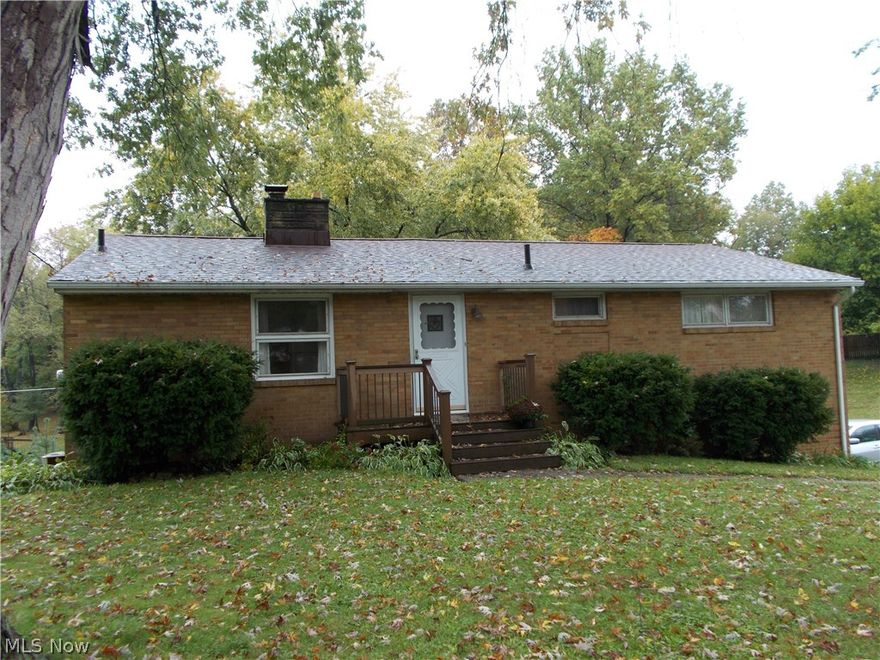 Sweet all brick raised ranch home has 3 Bedrooms and 1.5 Baths.  Vaulted ceiling in Living room and Kitchen.  Hardwood floors in bedrooms and hallway.  Family room in the basement walks out to patio and back yard.  Deck on back with view of big back yard and woods.  Perry schools.  Close to shopping, I-77 & airport.  A great home.  Accessible from 2 streets.  Square footage does not include basement area. Seller will consider offers!