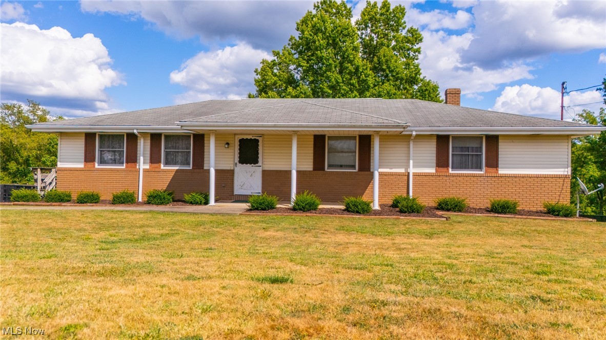 Welcome to this spacious 4 bedroom 2.5 bath ranch style home on 3/4 acre outside of city limits. This house will shine with your visioned updates to make it your own! Large living room, dining room and attached kitchen. Primary suite with full bath and large closet. 2 additional bedrooms and a full bath complete your spacious main floor living area. The lower level has a finished recreation room with a cozy wood burning fireplace. This walks out to a nice rear patio that has a large covered metal roof carport or picnic/grilling and chilling area. Another primary bedroom with its own half bath is perfect for family or guests. The large laundry room off the 2 car garage is also in the lower level. The home is landscaped for nice curb appeal and includes in the rear yard a large oak tree, dogwood tree, spacious shed, a level lot and huge driveway which wraps around to back, and always useful a clothesline. Enjoy peaceful views outside on the side deck or relax outback under the covered patio.