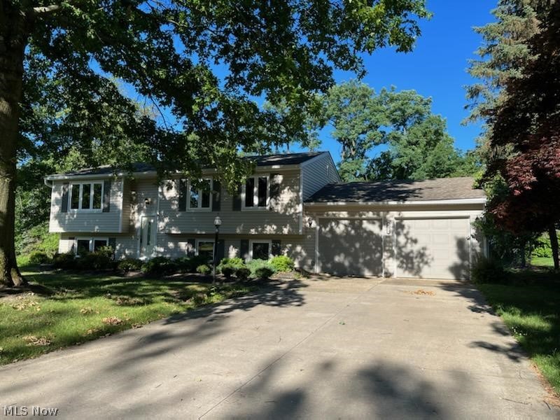 Spacious bilevel ready for your personal touch. Neutral colors throughout and newer windows provide lots of natural light. As you walk up to the main level you will like the open space that flows into the dining room. Remodeled kithen with all appliances, granite countertops, a deep farm sink and ceramic tile flooring. Just steps away is the 4 season sun room that over looks the private back yard and patio. 3 bedrooms, all with ample closet space, and a full bath. The lower level provides additinal living space with a family room with fireplace and a half bath, office/bedrom and a large area that has been used as a workshop/craft space. The convenient garage entrance is there, too. All carpets have been professionally cleaned, Vinyl/aluminium siding, roof, and windows have been updated.