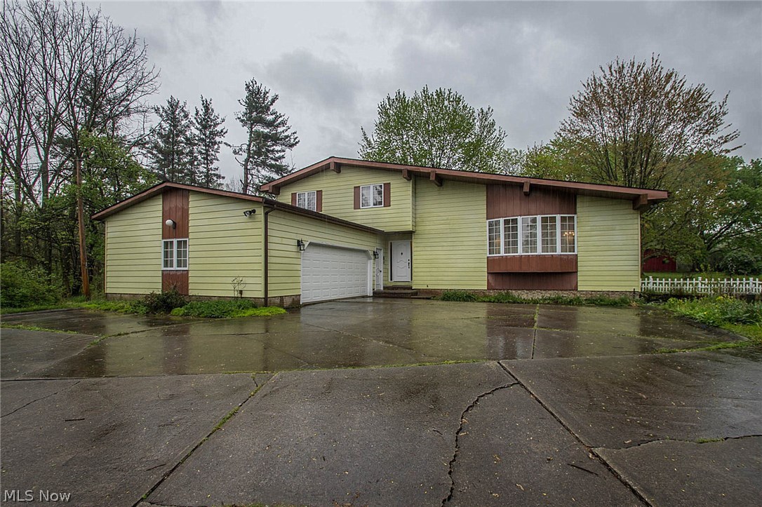One of a few North Royalton properties that allow horses! Country living with city conveniences! This one-of-a-kind, home sits close to the Metro Parks on 10 acres, yet minutes from I-77, shopping, restaurants, parks and more! A newly painted 22x44 barn w/ electricity sits on the property as well as a quaint pond for fishing. Extra spacious, 4-level, walkout basement, Split level style home boasts beamed, vaulted ceilings, a stone fireplace, walls of windows, 4 bedrooms & 3 full baths, an updated kitchen with granite countertops and all appliances stay! The 4th bedroom with attached full bath is located on the main floor, perfect guest quarters or home office! The walkout basement provides additional living space and houses an enormous workshop & loads of shelving for storage! Improvements: New Dishwasher (2017), New Roof (2013) w/ 50 yr warranty, Gutters/Downspouts (2013), Furnace (2010), Heat pump (2010), Hot water tank (2013). Home exterior will be professionally painted wi