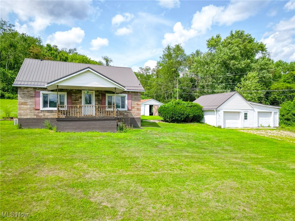 Tranquility at its finest! 43818 Sherwood is a cozy, three bedroom, one bathroom home that sits on a clear, flat acre of land in a peaceful setting. This property features an oversized, detached garage, as well as another building that could be used as a separate hangout, work area, greenhouse, or anything else you can imagine! The home features two bedrooms on the main floor, one upstairs, and a main-level laundry area that could be converted into an office space or fourth bedroom. 43818 Sherwood boasts new metal roofs on the home and the garage. Other updates include a remodeled bathroom, windows throughout most of the home, a newer water heater, and newer flooring in the kitchen and living area. Mineral rights DO transfer. The seller is very motivated, so call an agent now and make this miniature compound yours!
