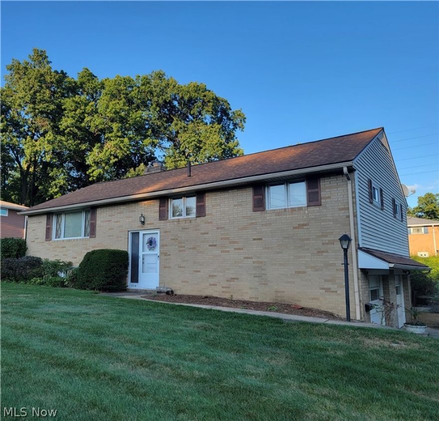 Welcome home to 504 Woodlawn!  This well-kept 3 bedroom, 2 full bathroom bi-level is just waiting for your updated touch to make it your own.  The main level holds the 3 bedrooms and 1 of the full bedrooms, along with large eat-in kitchen and open living room.  The natural lighting pours in from the big bay window and sliding glass door that goes out the back.  Downstairs is the second of the full bathrooms and living room with beautiful brick fireplace.  Two lots are included with this home, providing a large yard for entertaining or room for the kids to play. Don't miss out on your chance to call this house, home!