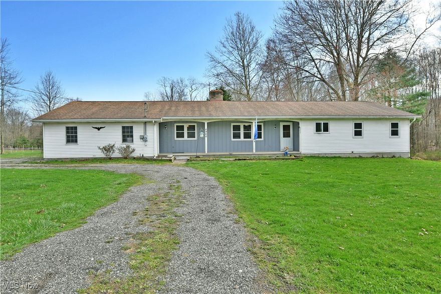 Potential packed with room to grow, this 5+ acre farmette is calling the name of anyone who is ready for the quiet country life. Located in a scenic, semi-rural setting with an expansive yard and a heavy wood line, this home offers natural privacy with great looks all around. A wraparound drive continues to find a three-car attached garage while the covered front patio welcomes you inside. While the spacious yard holds room for all kinds of outdoor activities, that is just the start of where the fun begins. A large barn can be found out back and is a great place to house any four-legged friends such as horses, cows, and other livestock. With trails surrounding the property for horseback or ATV riding, and other leisurely activities, this property is sure to entertain any outdoor and hunting enthusiast. Located next door, this property comes with the ability to utilize the largest indoor trail challenge arena on the East coast and is sure to not disappoint anyone who has a love for horses.  Inside, an oversized living room is dressed in hardwood-styled flooring as sunshine pours through the trio of windows. A woodburning fireplace ties into a stylish brick chimney at the far side of the room. Meanwhile, a separate rear family room and dining space sit opposite the picket lined basement stairway. Around the corner, the prominent kitchen enjoys a large serving window while wraparound countertops join the stainless-steel appliances and warm wood cabinetry. A pair of bedrooms are divided by a lovely full bath with a wood and tile trimmed tub, just steps past the kitchen. On the other side of the home, the impressively sized master bedroom showcases plenty of built-in casement storage along with both a walk-in closet and its own full private bath complete with its own jacuzzi style soaking tub. Below, the full basement offers easy workshop and storage solutions.