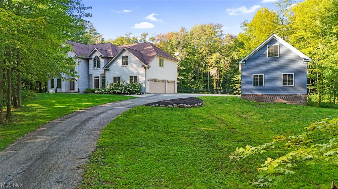 Are you looking for rural privacy with a suburban feel? Look no further than this gorgeous 4 bedroom, 2.5 bath, 3 car garage Colonial in Chagrin Falls with a brand new ginormous outbuilding and 3.88 acres for all of your outdoor toys/storage needs! Step in the front door and notice high ceilings, fresh paint and hardwood floors throughout. The first floor boasts a massive office featuring LVP flooring, built in office cabinets and an island for all of your in home office/work from home necessities. Cozy up in the family room overlooking the back yard that is off a massive open concept dining room and eat in kitchen. The Kitchen features updated cabinets, granite counter tops and added in island for all your kitchen needs all overlooking the fenced in backyard surrounded by woods (ALL APPLIANCES STAY). Walk upstairs to a massive master bedroom featuring huge walk in closets, master bath with walk in shower and jacuzzi tub for all of your privacy needs. The 3 bedrooms are large ad