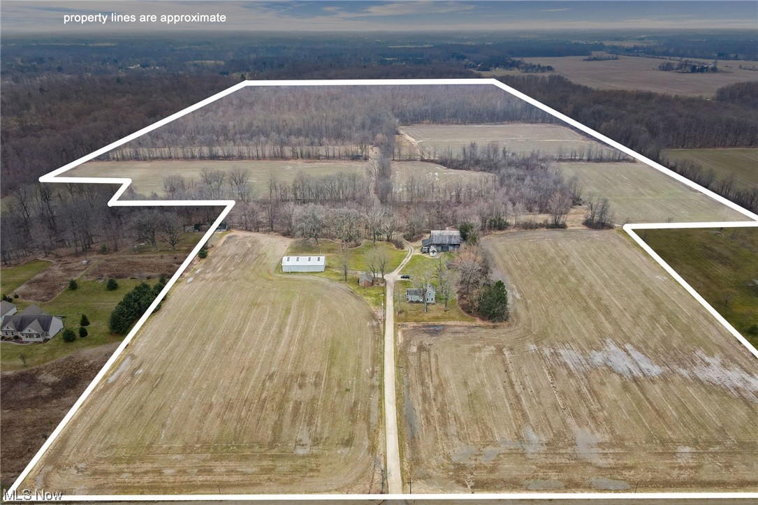 Welcome to this developers dream opportunity to build on this massive 84 acre lot. This partial wooded/lush land offers much potential with tons of room for farming and more. Included with the land, you will find a classic colonial home, a large pole barn, garage, and other useful outbuildings. City water is available with the possibility of gas as well. Perfectly placed between Station Road & W River Road, don’t miss out on the chance to complete your vision. Currently zoned as field and seed, buyers to do their due diligence if they want to get it rezoned for development and verify CAUV tax amounts and rules.