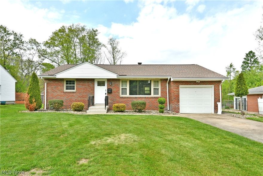 With its all-brick construction, desirable ranch layout, and move-in-ready condition, this attractive Hubbard Township home is sure to impress. Offering a spacious three-bedroom layout and two levels of living space, you will love the partially finished basement, complete with a bar and rec area, perfect for entertaining. Tucked away on a quiet street, the home boasts great curb appeal with classic brickwork, a concrete driveway, and an attached one-car garage. Outside, a manicured rock bed surrounds a generous patio space, ideal for relaxing or hosting summer gatherings. Step inside to find a bright and spacious living room filled with natural light from a large picture window, highlighting the hardwood-style flooring. Decorative columns and a built-in feature wall create a unique focal point, perfect for display or an entertainment setup. The adjacent kitchen offers stainless steel appliances, ample cabinetry, and a comfortable dining area with great views of the backyard. Down the hall, you will find three well-sized bedrooms along with a beautifully updated full bath featuring a stylish vanity. The partially finished lower level adds even more living space, showcasing a retro-inspired bar and rec area that’s perfect for entertaining. Additional laundry, workshop space, and a second full bath complete the basement. Updates include: roof 2019, furnace & air conditioner 2020, hot water tank 2016, vinyl replacement windows 2012, glass block windows in the basement 2015, LVT flooring throughout the first floor 2019, new wiring/breaker box 2016, all new interior & exterior lighting 2016, new entry doors 2016, exterior drainage pipes 2020, gutter helmets 2020, and so much more! Plus a one-year home warranty!