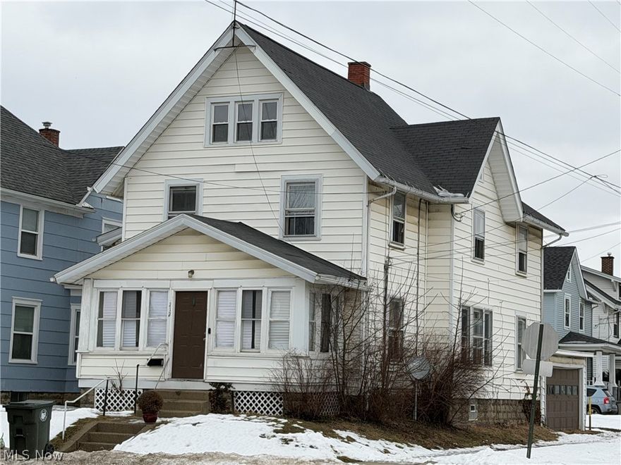 Spacious 4-bedroom, 1.5-bath Colonial offering approximately 1,644 square feet of living space. Situated on a corner lot, this two-story home features a full basement, enclosed front porch, and detached 2-car garage with off-street parking. Interior highlights include original woodwork, formal dining room, main-level bedroom, and two decorative fireplaces that add character and architectural detail. Previously configured as a duplex, presenting flexibility for future use (subject to buyer verification and local regulations). Property is being sold As-Is.