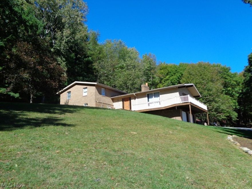 This secluded setting offers 10.65 acres with wooded areas in a country setting just minutes away from town! Split level home features wrap around the side porch/deck area to sit out and enjoy the views and wildlife. The cozy large living room with cathedral ceiling,  many windows/slider door  and wood burning stone wall fireplace. Fully applianced kitchen with plenty of counter space/center island/pantry overlooks dining area. Second Level has master bedroom with private full bath and 2 double closets. Three other sizeable bedrooms and updated full bath. Lower level has finished family room. Large laundry area and 17x16 storage room w/many storage shelves. Work room w/work bench area. Two Car Attached Garage.