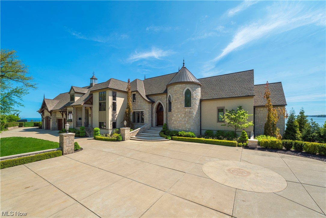 Discover a stunning waterfront estate with breathtaking panoramic views of Lake Erie and downtown Cleveland. This magnificent home is nestled on the curve of the shoreline on the west side of Cleveland, offering a sense of tranquility and relaxation. The luxurious outdoor living space is perfect for summer living, with a saltwater pool, pool house, and boathouse with a rooftop patio. The boardwalk leads to the boat and personal watercraft dock, and the fully finished walk-out basement with wine grotto is the ideal place to unwind after a long day on the water. The interior is equally impressive, with volume ceilings throughout, a cook's dream kitchen with high-end appliances, and a laundry room with additional storage and appliances. The first-floor owner's suite features gorgeous views, and the private office is complete with built-ins. With 5 additional bedrooms and 5 full and 2 half bathrooms, this property is perfect for both relaxation and entertainment. Don't miss out on the rare opportunity to own a truly remarkable waterfront estate. Contact us today to schedule your exclusive private VIP tour!