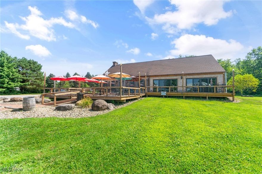 Nestled on five picturesque acres, this established winery offers a rare opportunity to own a thriving business in a breathtaking setting. The expansive building features a welcoming tasting room perfect for showcasing the winery’s impressive selection of over 17 varieties of handcrafted wines. A spacious additional room is ideal for private parties or special events, creating endless possibilities for hosting guests year-round. The property includes a fully equipped kitchen to pair gourmet bites with wine flights, as well as outdoor seating on a scenic deck with umbrella-covered tables. Guests can also gather around the large firepit area, taking in the fresh air and unforgettable sunsets. With its perfect blend of charm, functionality, and potential, this winery is ready to continue its legacy—or start yours.