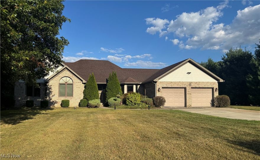Welcome to this spacious three-bedroom ranch, perfectly designed for comfort inside and curb appeal outside. This home features a beautifully landscaped lot, a classic brick and vinyl façade, and a timeless hip roof that adds to its charm. The owner's suite is a true retreat with a walk-in closet, garden tub, and dual vanities. The large eat-in kitchen offers wood cabinetry, an abundance of countertop space that includes a breakfast bar, a built-in desk, and a bay window emitting natural light into the space.  The formal dining room offers an elegant space for gatherings. The living room is warm and inviting with a corner gas fireplace and wood trim accents, complemented by wall-to-wall carpet which can also be found throughout most rooms. Two additional bedrooms, including one with a striking palladium window and double closets, share a full hallway bath with a walk-in tub/shower. A mud/laundry room with half bath is conveniently located off the attached two-car garage. The full unfinished basement provides endless possibilities for storage or future customization. A large outbuilding is located in the back on this 2.46 acre lot. This charming home exudes character and offers unpolished potential, waiting for your personal touch to truly shine.