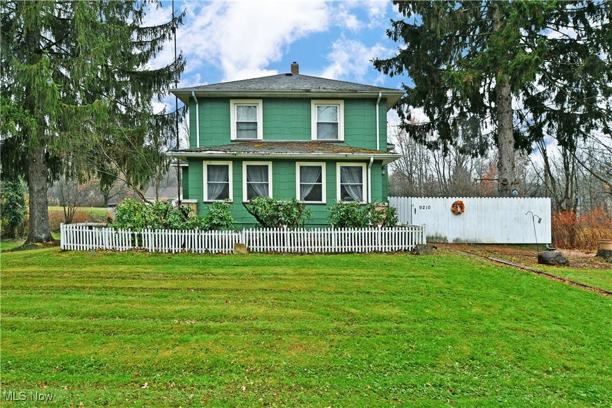 Bold colors and cottage-like vibes will have you falling in love with this unique Howland home! Sat on an impressively sized lot, the engaging home lies beneath a pair of tall pines, showcasing its white picket fences that give storybook design elements. A wraparound driveway snakes past the expansive brick patio to find both a detached two car garage and a single car attached unit that leads to basement storage and laundry space alike. The rearward entry enjoys an enclosed and finished porch, easily doubling for a coat and mud room. Steps past, a cozy corner kitchen presents its stone-look countertops and warm wood cabinetry. Opposite, a short hall leads to a bonus office or potential bedroom with a full first floor bath. Meanwhile, the inviting dining room draws you near with carpeted flooring and the main staircase access. A relaxing living room completes the floor before 
leading to a sunroom. Upstairs, three sizeable bedrooms branch from the main landing as they are joined by a sizeable full bath with tiled flooring and tasteful updates. Bonus features include a potting room next to the garage, perfect for gardening.