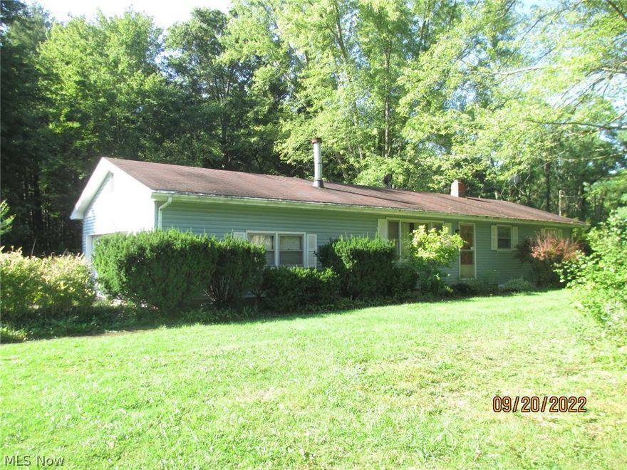 Ranch on 2.30 acres in Champion. Needs some work, potential to be nice home on spacious property. 2 parcels, 200 x 500. Extra 24 x 24 garage built in 1995. Basement waterproofed by Ohio State Waterproofing. Hardwood floors. Dining room is addition that could be family room. Sanitary sewer line in process. Buyer assumes fees. Gas at street. Property being sold "as is".